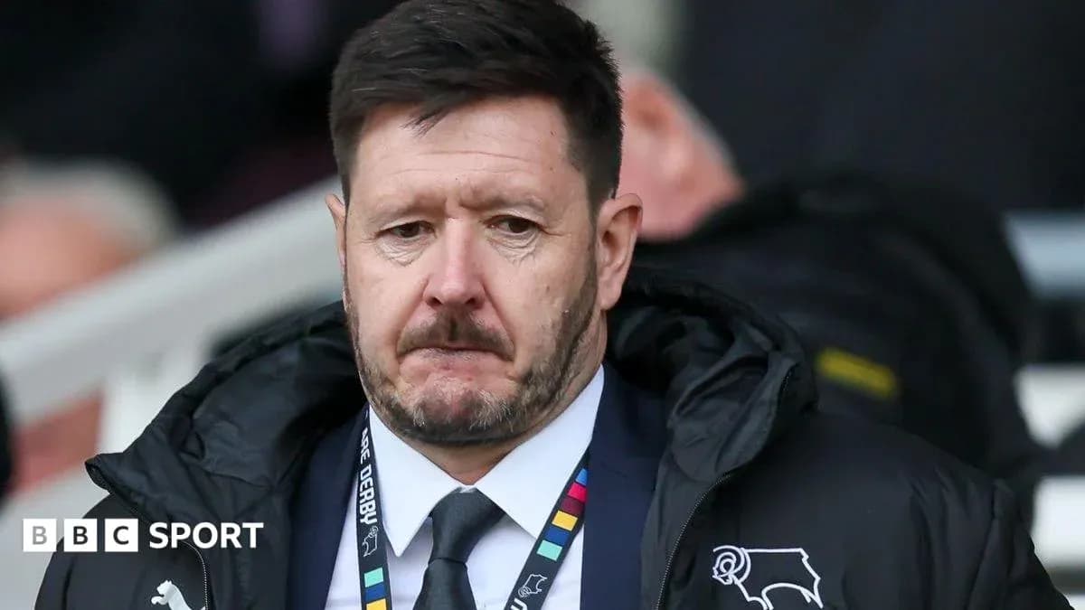 Manager wearing Derby County jacket on sidelines