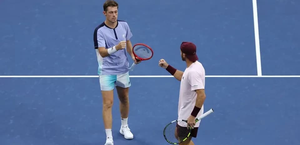Two tennis players celebrating on the court