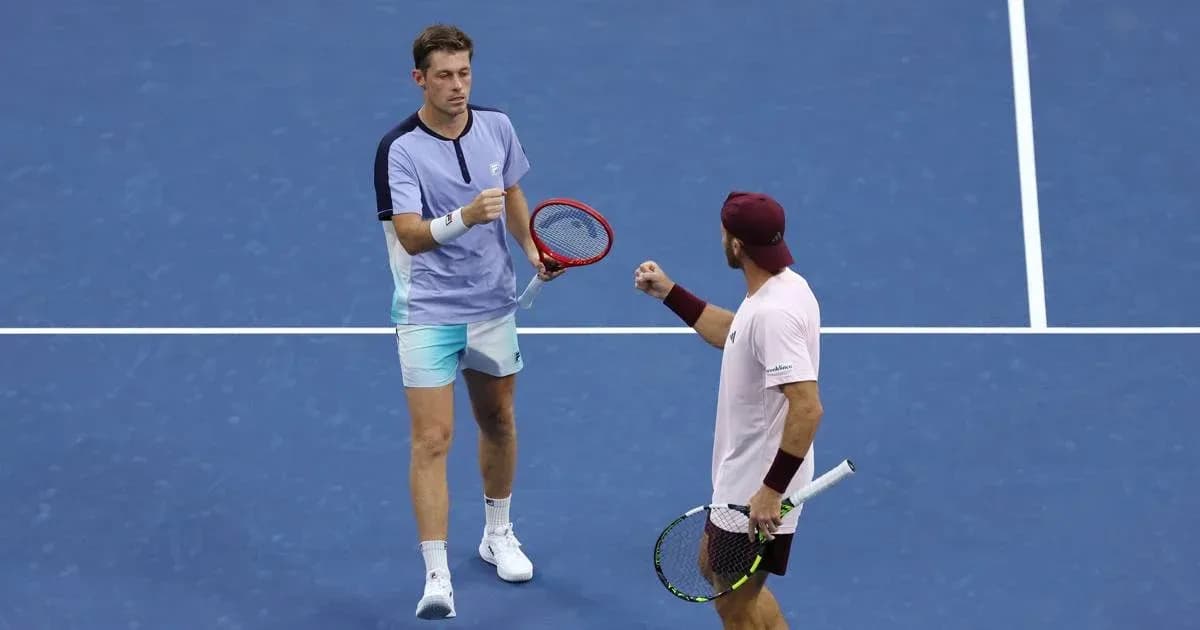 Two tennis players celebrating on the court