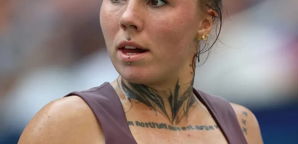 Athlete with tattoos during tennis match action