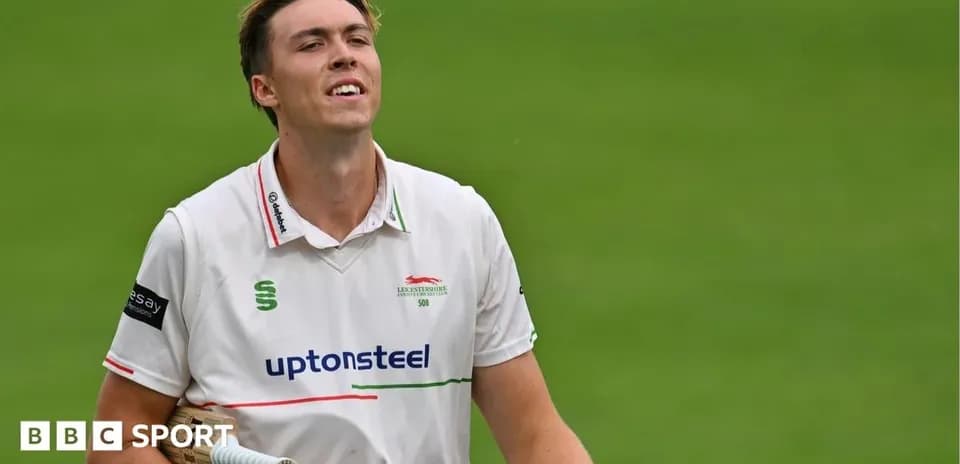 Cricketer walking off field after batting performance