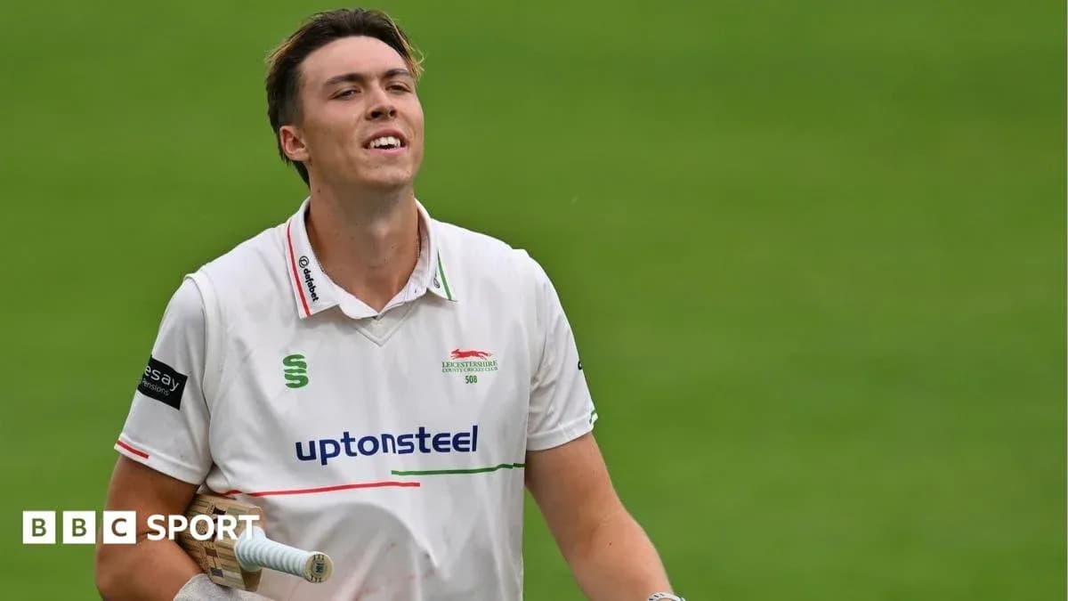 Cricketer walking off field after batting performance