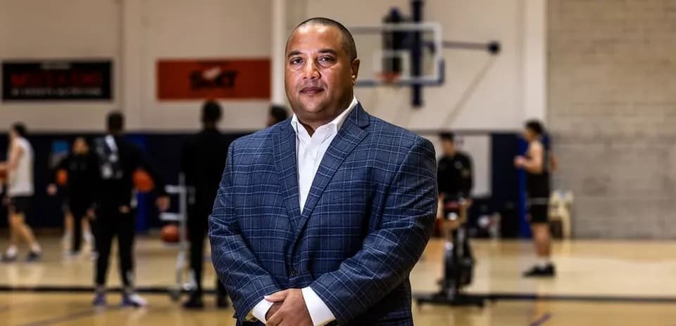 Coach standing in front of basketball practice session