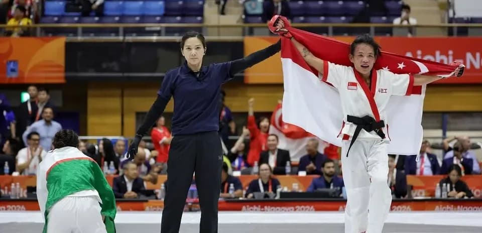 Athlete celebrating victory with national flag raised