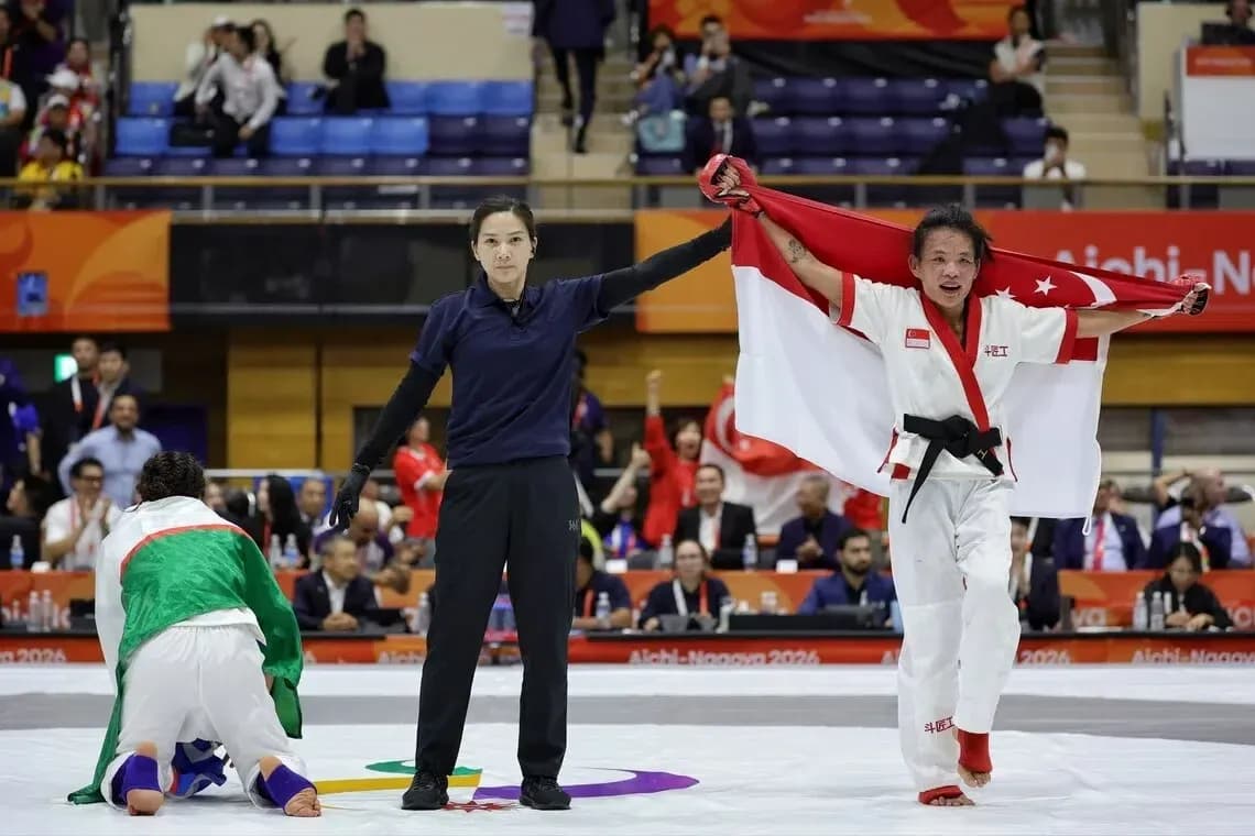 Athlete celebrating victory with national flag raised