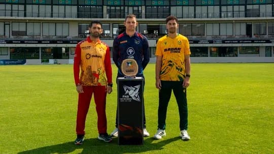 Three cricket players posing with trophy on field