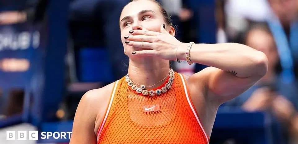 Tennis player celebrating with hand gesture on court