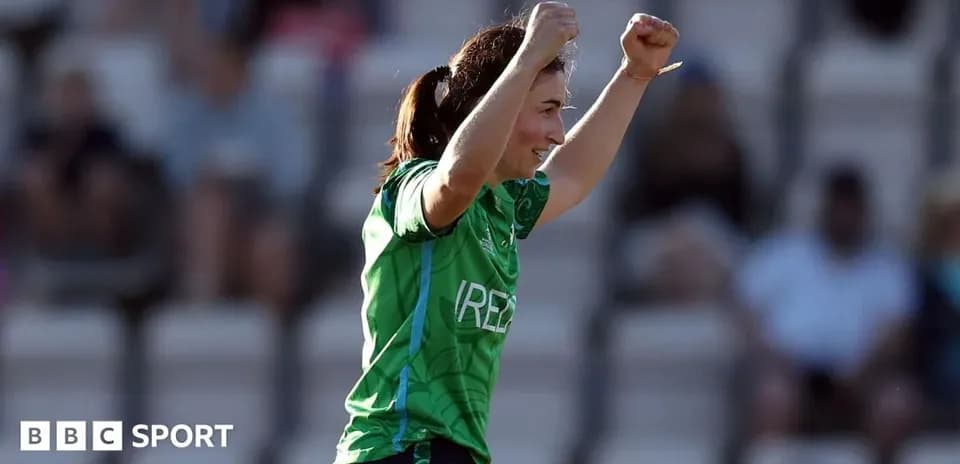 Player celebrating during a match in green jersey