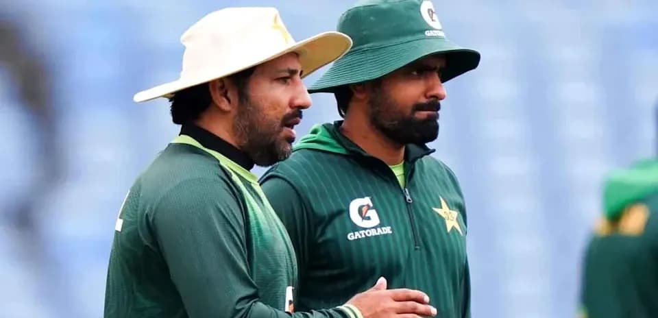 Two cricketers in training gear discussing together