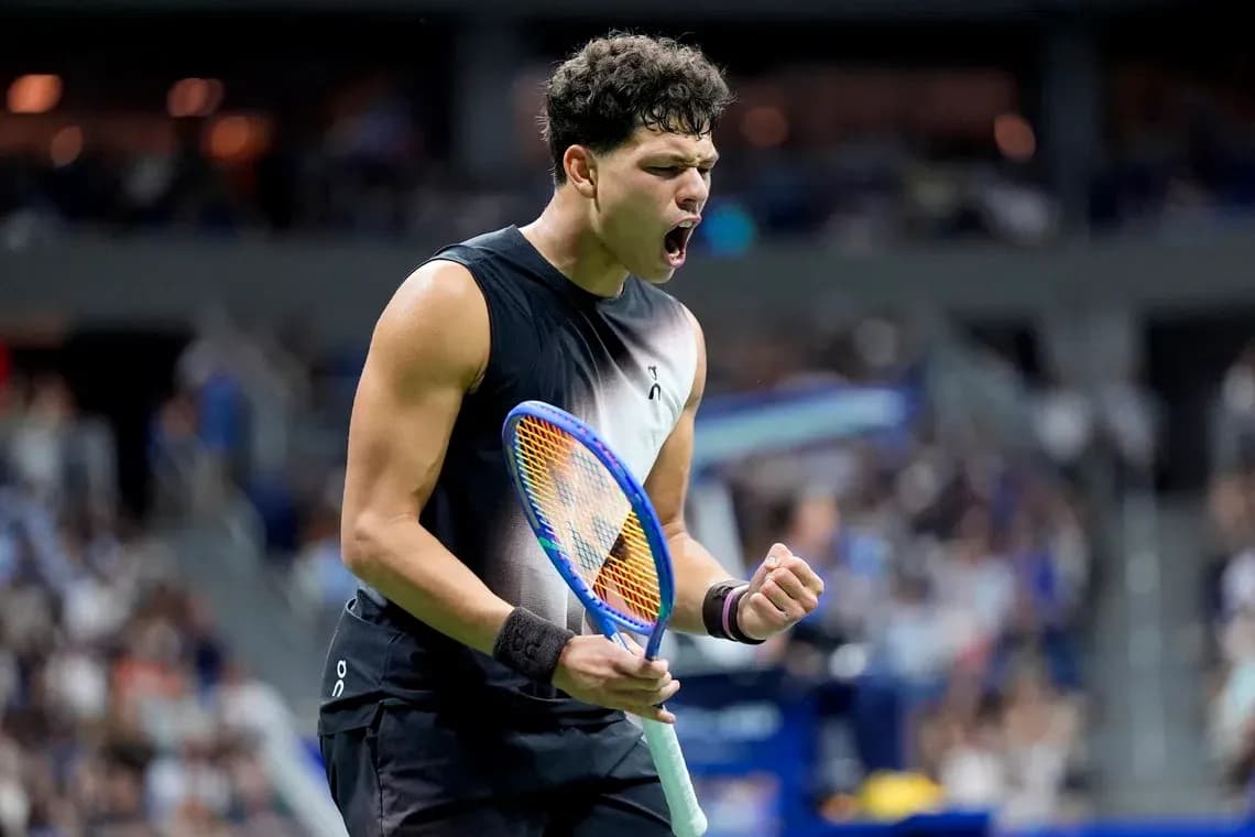 Tennis player celebrating with racket after winning point