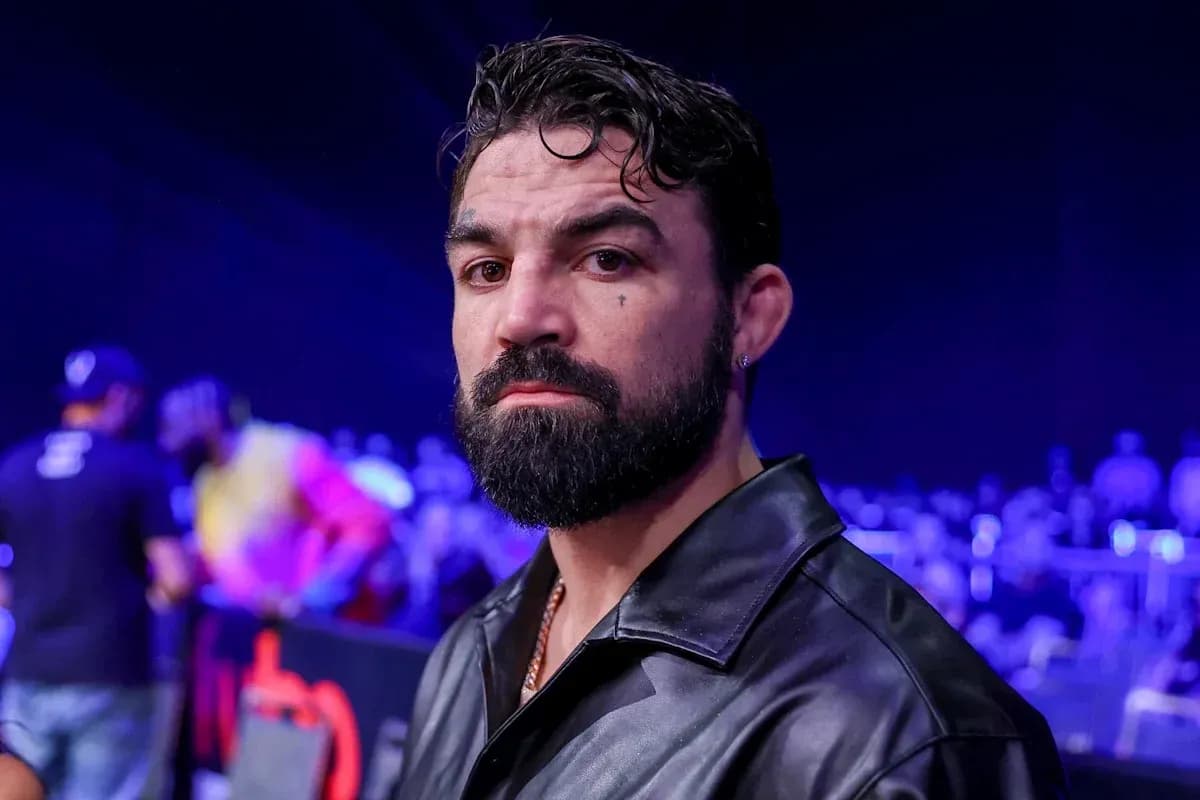 Man with beard in black jacket at event