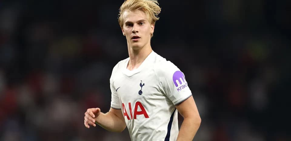 Player in Tottenham jersey running on the field