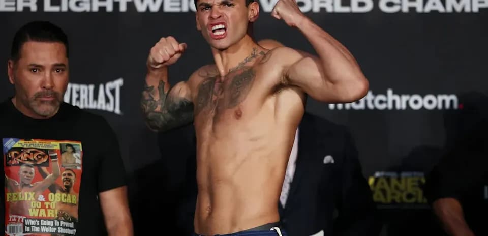 Fighter flexing muscles at weigh-in event