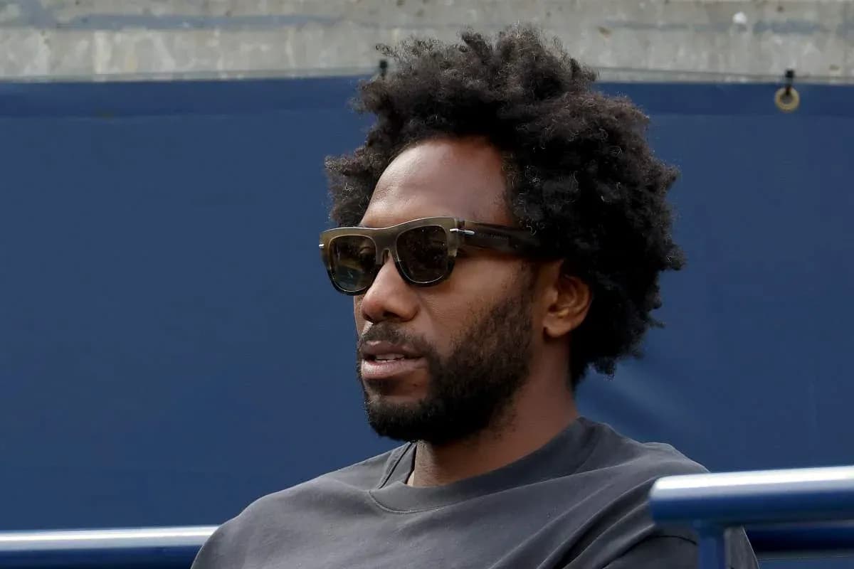 Man with sunglasses sitting in the stands