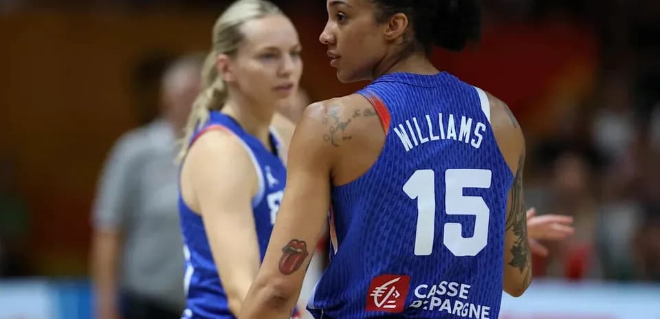 Two basketball players in blue jerseys during game