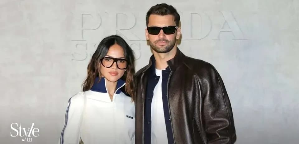 Couple posing together in stylish outfits