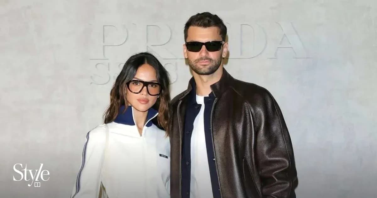 Couple posing together in stylish outfits