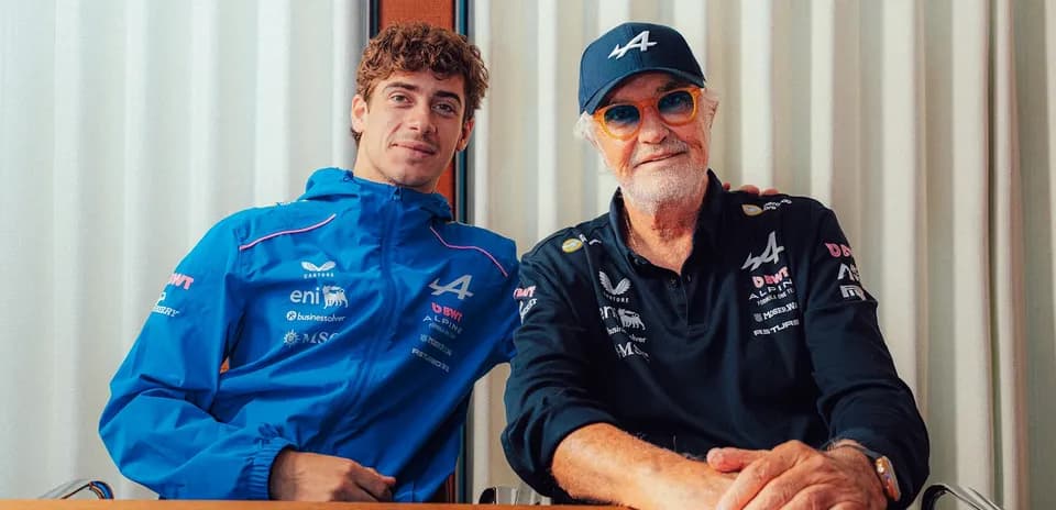 Two men posing together at a table