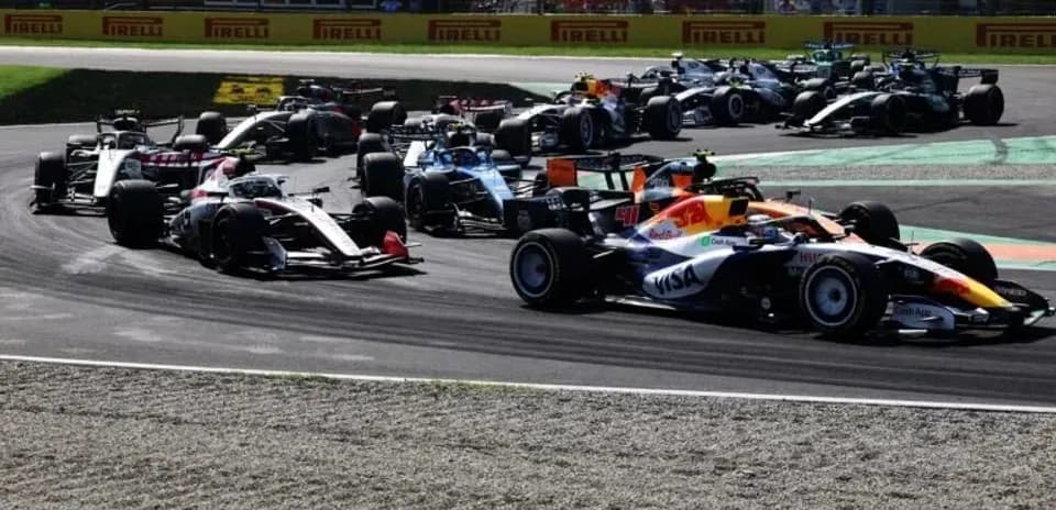 Multiple Formula 1 cars racing on track corner