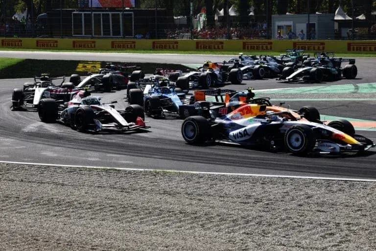 Multiple Formula 1 cars racing on track corner