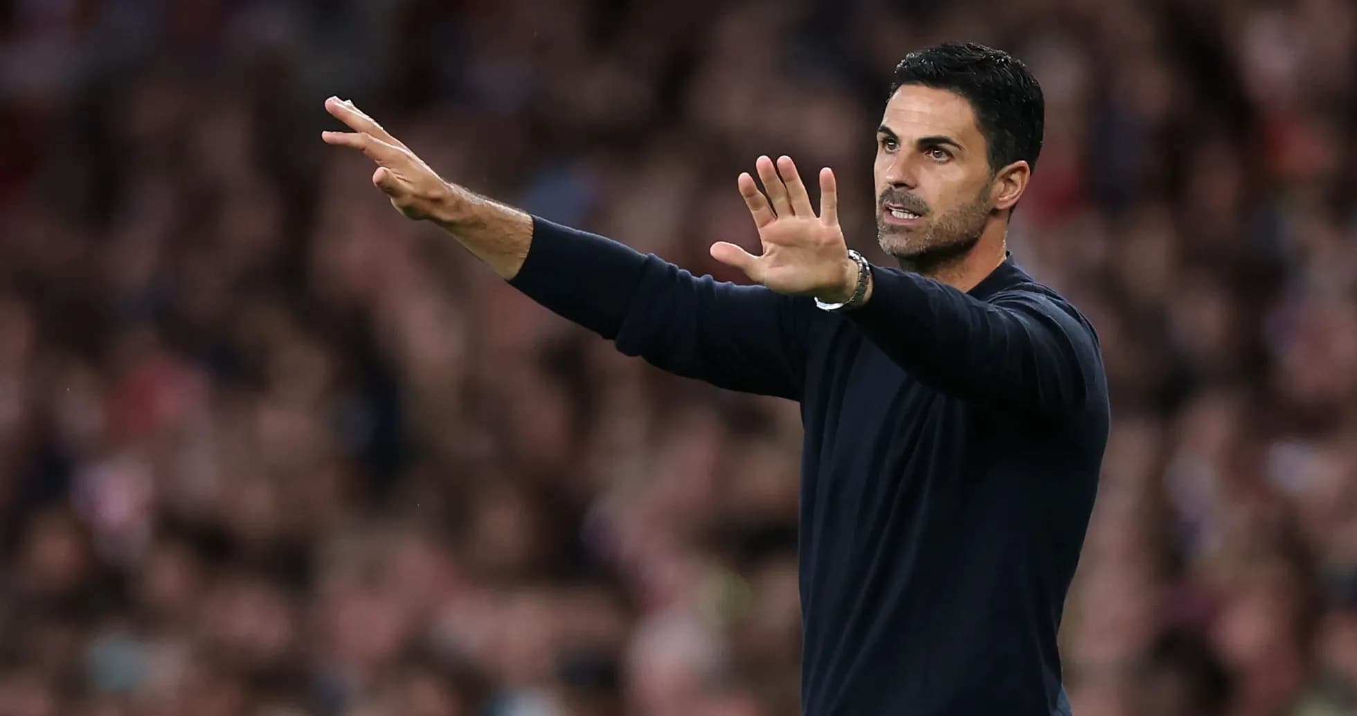 Manager gesturing from the sidelines during match