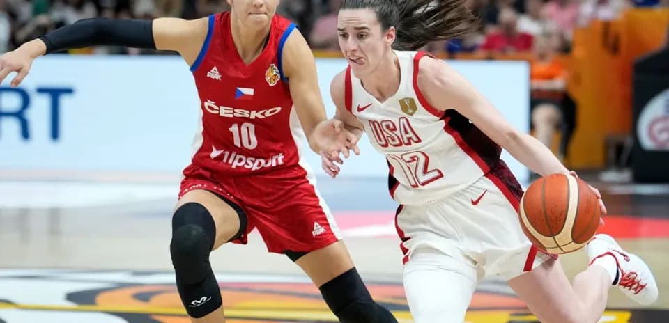 Player from USA dribbling past opponent in red jersey
