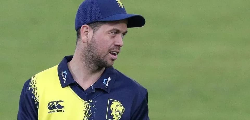 Cricketer wearing team uniform on the field