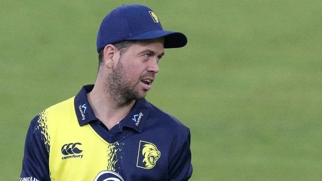 Cricketer wearing team uniform on the field