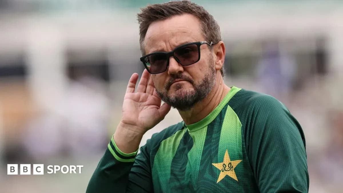 Cricket coach listening intently during practice session
