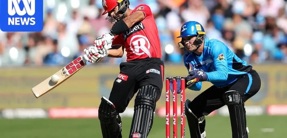 Batsman striking the ball while wicketkeeper crouches