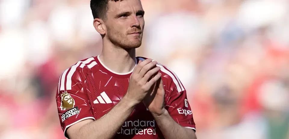 Player applauding fans in red jersey during match