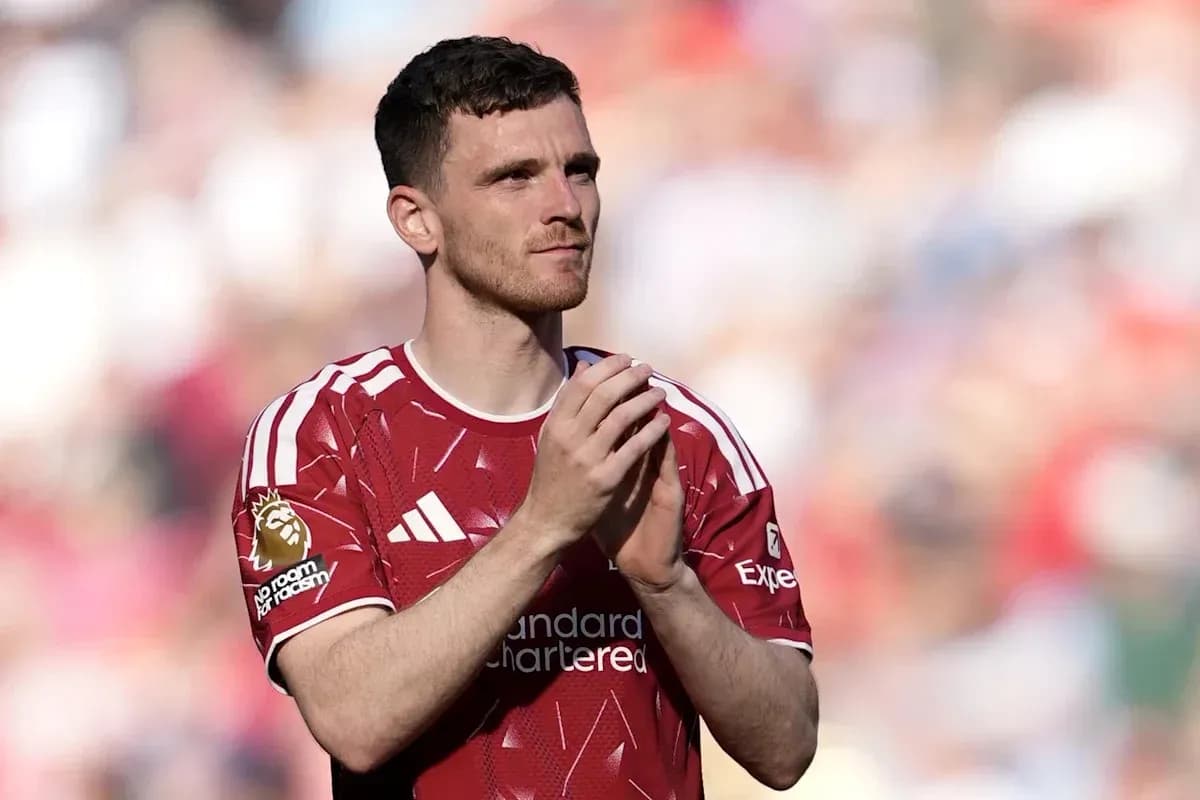 Player applauding fans in red jersey during match