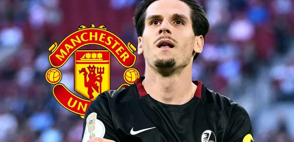 Player in black jersey with Manchester United logo backdrop