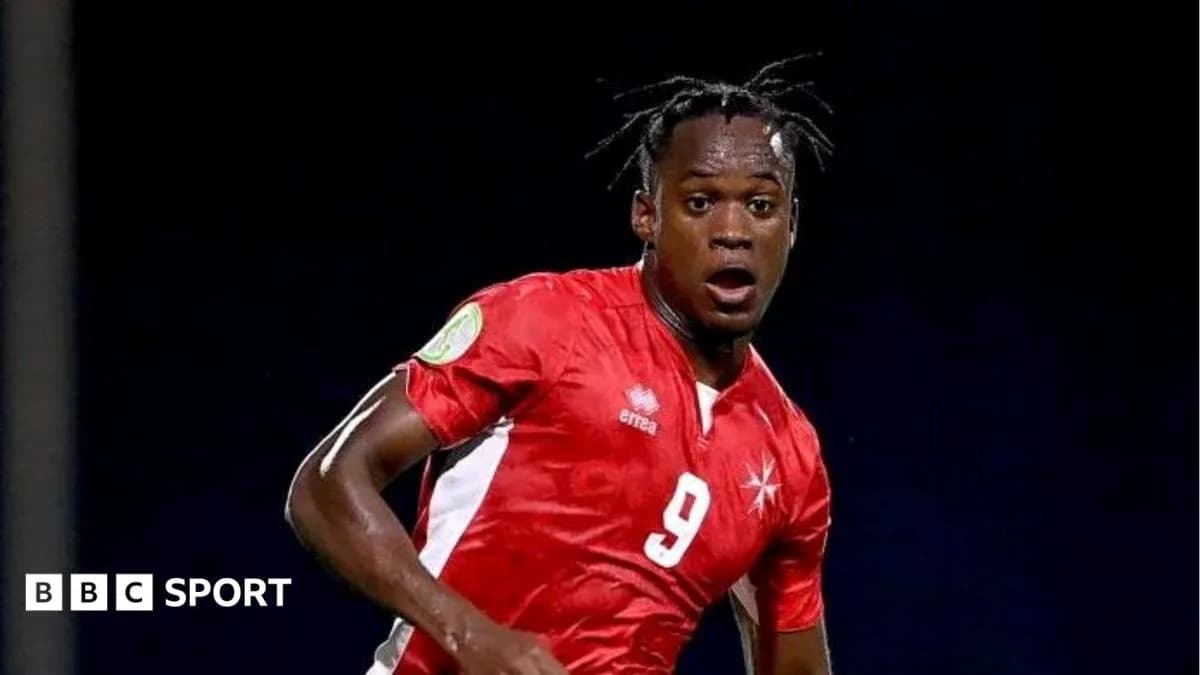 Player in red jersey during football match action