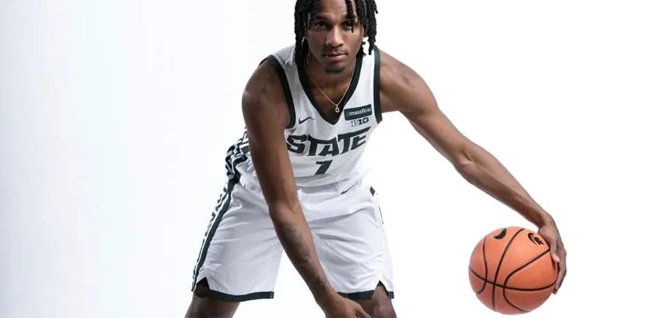 Basketball player dribbling a ball in uniform