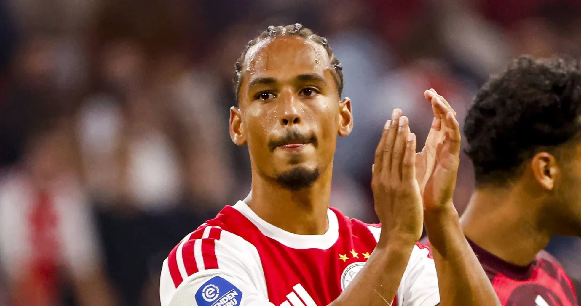 Player applauding fans after match at stadium