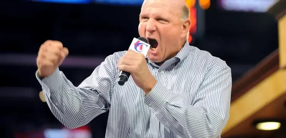 Man passionately speaking into a microphone at event