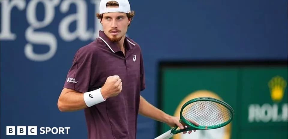 Tennis player celebrating with racket on court