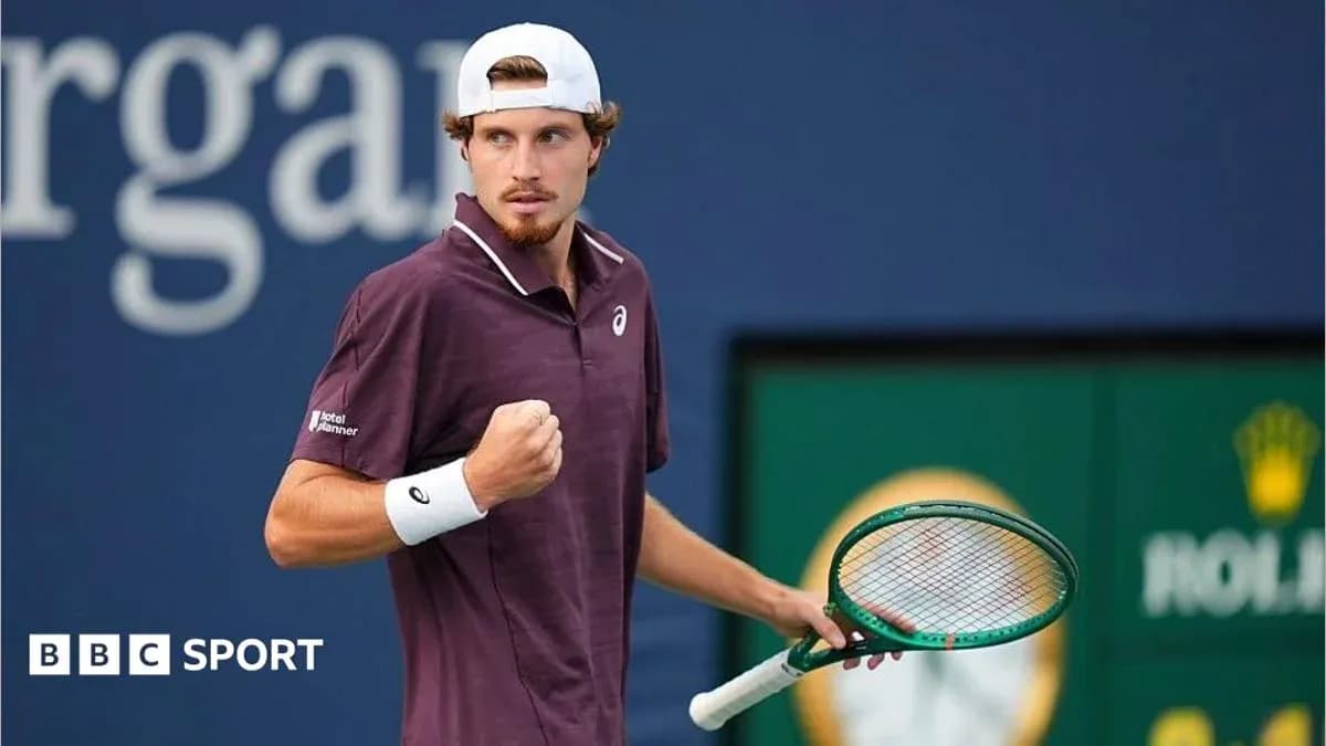 Tennis player celebrating with racket on court