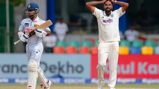 Bowler reacts while batsman walks back to pavilion