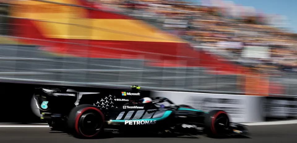 Formula 1 car speeding on track with crowd backdrop