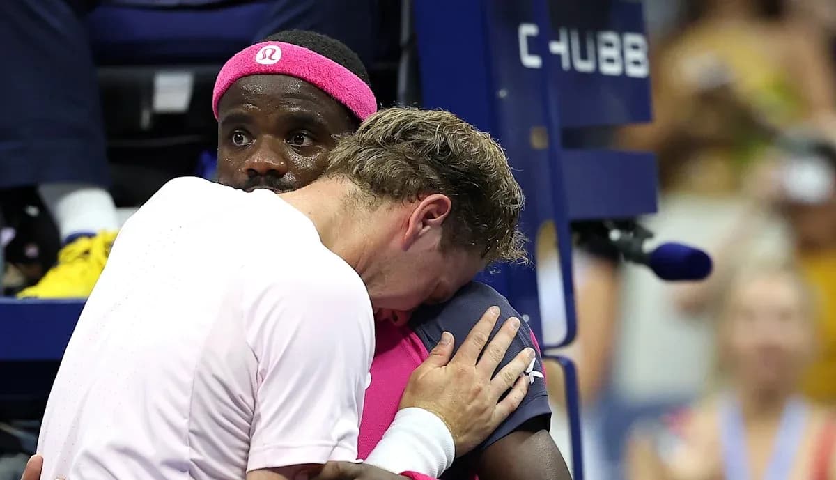 Two tennis players embracing during a match
