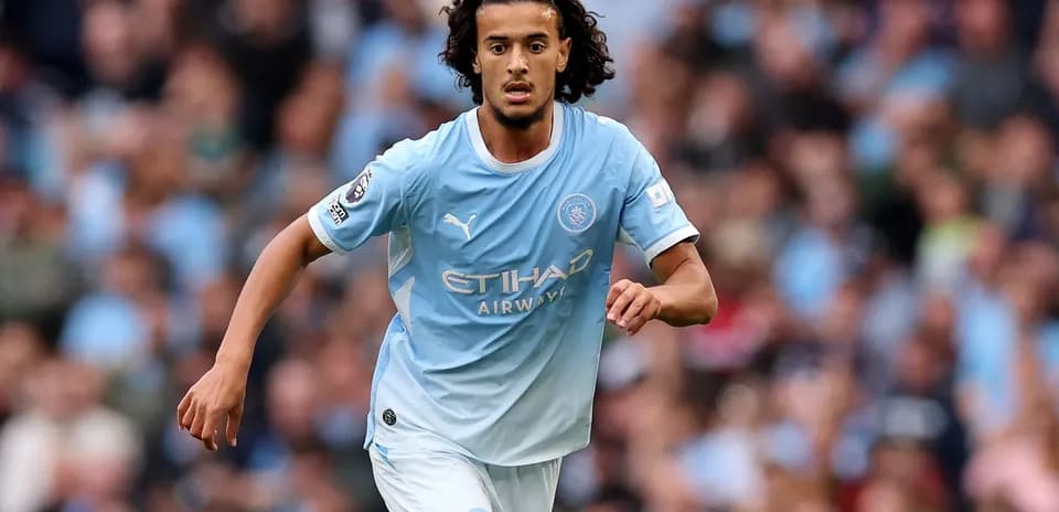 Player running on the field in Manchester City kit
