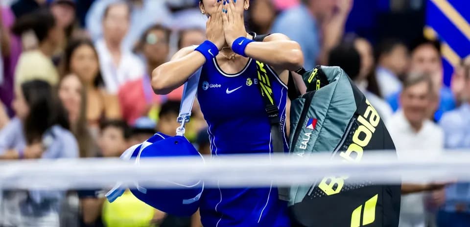 Tennis player celebrating after match with bags