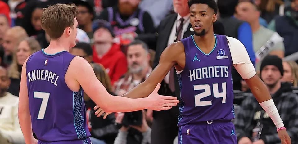 Two Charlotte Hornets players celebrating during game