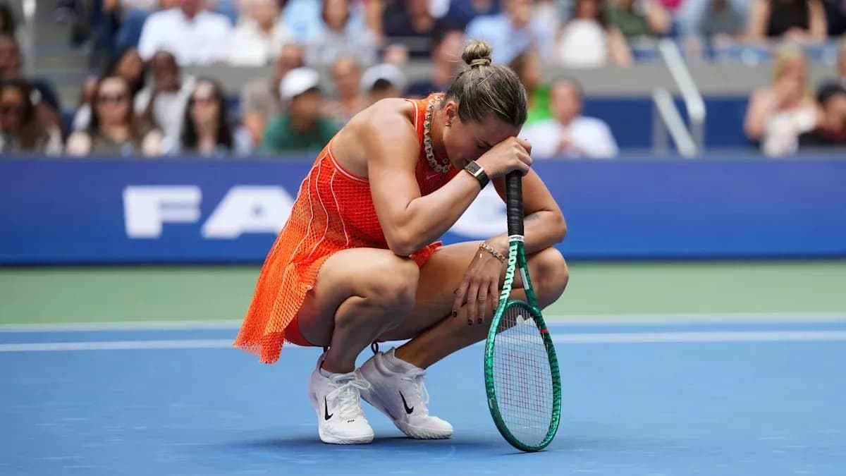 Player kneeling on court, holding racket and head down