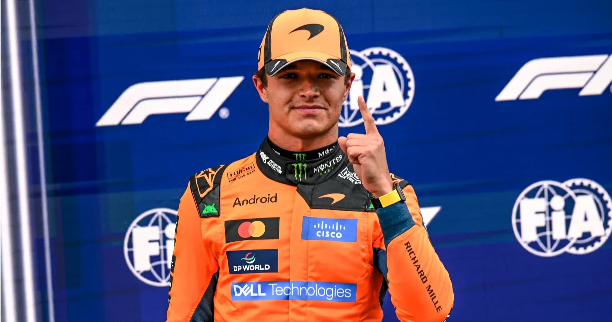 Driver celebrating with number one gesture on podium