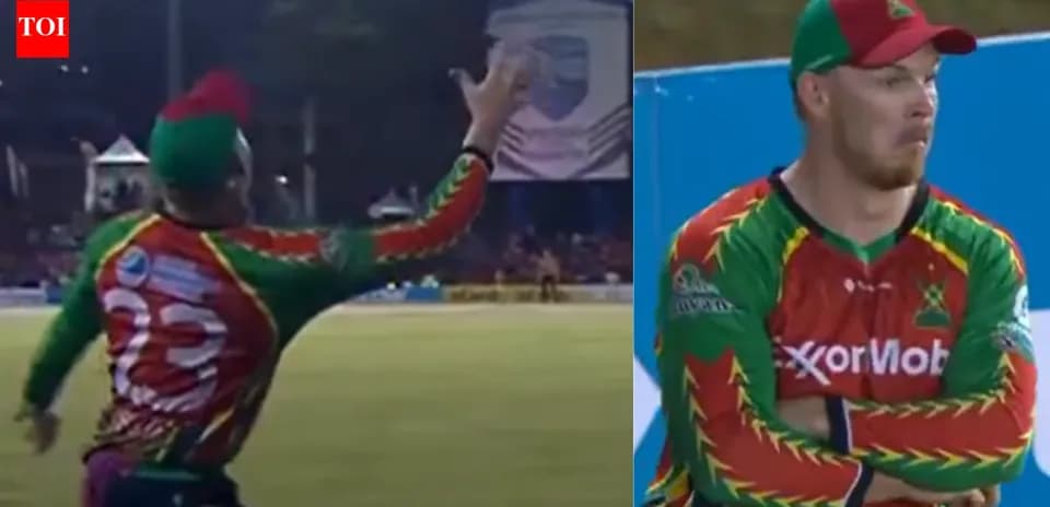 Cricketer catching ball during match play