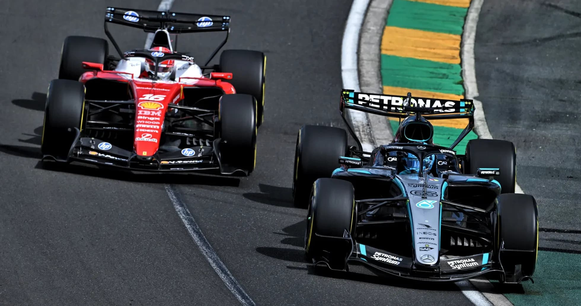 Two Formula 1 cars racing on track during competition