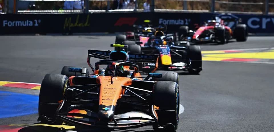 Formula 1 cars racing on a circuit track